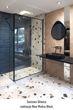 a bathroom with a sink, mirror and shower stall in the middle of the room