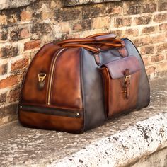 Ideal for overnight or weekend trips, the travel duffle is the best option to carry all your essentials in style. There’s virtually no place where a leather duffel bag would feel awkward or out of place. It measures 21.6 x 11.8 x 11.0 inches / 55 x 30 x 28 cm and features an outside pocket perfect for the little items that could otherwise get lost at the bottom of your bag, full lined interior and a removable shoulder strap. THE DETAILS: Materials: grey painted calf + med brown painted calf + da Barber Accessories, Designed Shoes, Leather Duffel Bag, Leather Duffel, Custom Design Shoes, Casual Tote Bag, Travel Duffle Bag, Leather Duffle Bag, Hot Style