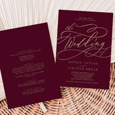 the wedding stationery is laid out on top of a wicker basket and it's maroon color