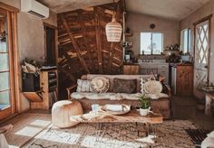 a living room filled with furniture and lots of wood planks on the wall behind it