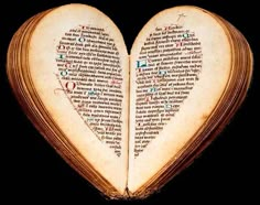 an open book in the shape of a heart with writing on it's pages