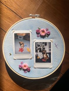 two pictures on a table with flowers in the middle and an embroidered frame around them