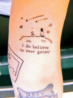 a person with a tattoo on their arm that says i do believe in your galaxy