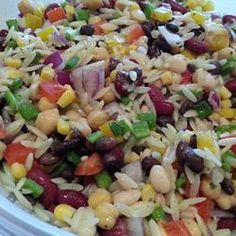 a bowl filled with rice, beans and veggies on top of a table