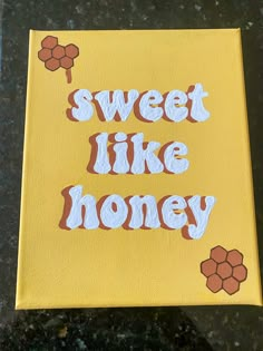 a yellow canvas with the words sweet like honey painted on it in white and brown