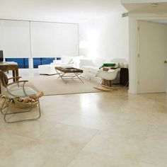 a living room filled with furniture and white walls