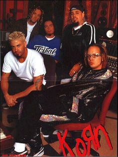 a group of young men sitting next to each other in front of a recording studio