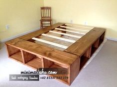 a wooden bed frame sitting in the middle of a room