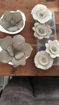 some white flowers sitting on top of a wooden table