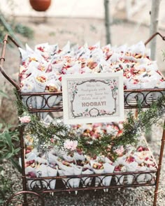 a table topped with lots of food covered in white and pink napkins next to a potted plant