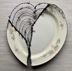 a broken plate with some branches on it