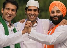 three men in turbans are posing for a photo together, one is holding his arm around the other's shoulder