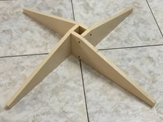 a close up of a wooden object on a tile floor with no one around it