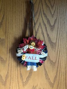 a fall decoration hanging on a wooden wall