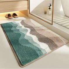 a bathroom with a rug on the floor next to a mirror and shoes in front of it