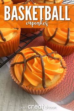 cupcakes with orange frosting and chocolate drizzled on top, sitting on a cooling rack