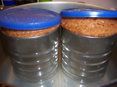 two plastic containers filled with food sitting on top of a metal counter next to each other