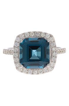 An asscher cut stone adds an art deco style to this 14K white gold ring trimmed in pave diamonds. 0.5" L x 0.5" W ring face 14K white gold, London blue topaz, diamonds 0.45 ctw Imported Topaz Diamond Ring, Diamond Flower Ring, Gold Flower Ring, Bezel Set Diamond, Asscher Cut, Diamond Flower, 14k White Gold Ring, White Gold Ring, London Blue Topaz