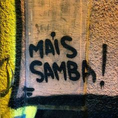 graffiti on the side of a building reads mai's samba and it is written in black