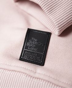 the label on a pink polo shirt that says,'the black book club '