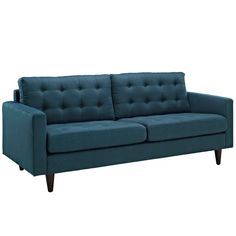 a blue couch sitting on top of a white floor