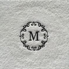 a monogrammed towel with the letter m in black and white on top of it