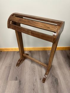 a wooden table sitting on top of a hard wood floor next to a white wall