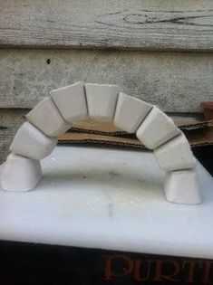 a close up of a fake arch made out of foam on a shelf next to a door