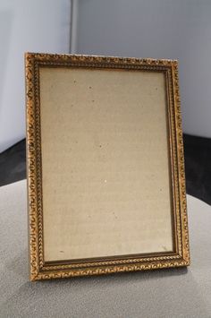 an old photo frame sitting on top of a table