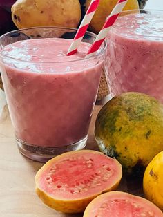 two glasses filled with smoothie next to some fruit