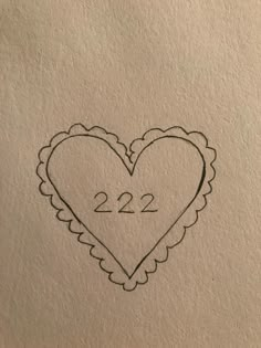 a drawing of a heart with the number 22 on it's side, in black ink