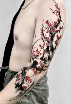 a person with a tattoo on their arm and the other arm is covered in red flowers