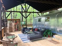 a living area with couches, chairs and an airstream