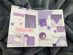 an open book on a blanket with pictures and words written in pink, purple and white