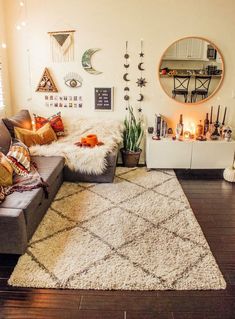 a living room filled with lots of furniture next to a fire place and a round mirror