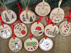 christmas ornaments are hanging on a wooden table