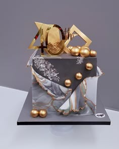 the cake is decorated with gold and silver decorations