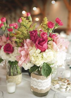 two vases filled with pink and white flowers