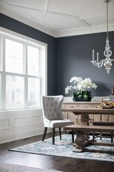 a dining room table with chairs and a chandelier