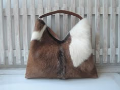 "SHOULDER BAGS For WOMEN Handbags in Brown White Hide Hair Leather Totebag Animal Print Purse Casual Designer Handbags Gift For Her Daily Bag. Multi Tasking work, planning dinner, this furry chic bag  is for those of us that need to find our essentials quickly. Wide opening with a magnetic clasp. Size Cm : Length 46 cm X High 26 cm X Wide 5.5 cm Size Inches : Length 18\" x High 10\" x Wide 2.1\" Cotton Drill Lining.     100% Hide Hair/ Leather     Adjustable/ detachable shoulder strap     We han Trendy Brown Shoulder Bag With Animal Design, Brown Animal Design Shoulder Bag For Shopping, Leather Tote Shoulder Bag With Animal Design, Cow Hide Purses, Purse Casual, Office Documents, Work Planning, Western-themed Brown Leather Shoulder Bag, Cowhide Purse