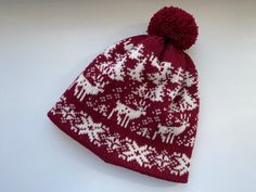 This woolen hat with reindeer and snowflake patterns is a perfect blend of warmth and comfort. Crafted from 100% natural sheep's wool, it offers excellent insulation during cold weather. The hat is lined with soft merino wool, ensuring extra warmth and comfort while being gentle on the skin. This hat is both stylish and practical for outdoor activities in chilly conditions. Its snug fit and pom-pom detail on top add a playful touch to a timeless design, making it ideal for winter wear or as a th Wool Hat Knit, Warm Winter Hats, Wool Mittens, Winter Set, Winter Hats For Women, Knit Mittens, Snowflake Pattern, Red Wool, Wool Hat