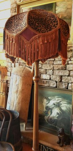 a lamp that is sitting on top of a wooden stand in front of a brick wall