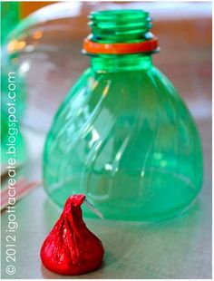 there is a green bottle with red candy in it