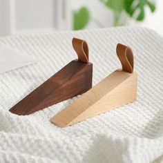 two pieces of wood sitting on top of a white blanket