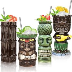 three tiki glasses with fruit and vegetables in them