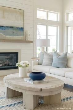 a living room filled with furniture and a fire place in front of a painting on the wall