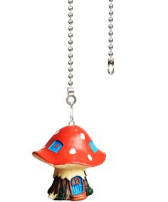 a red mushroom shaped keychain hanging from a chain