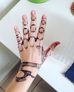 a woman's hand with tattoos on it