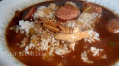 a white plate topped with meat and rice covered in gravy