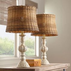 two lamps sitting on top of a wooden table